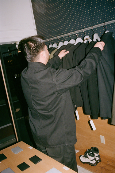 Ryuichi wearing vowels Chore Jacket in Black